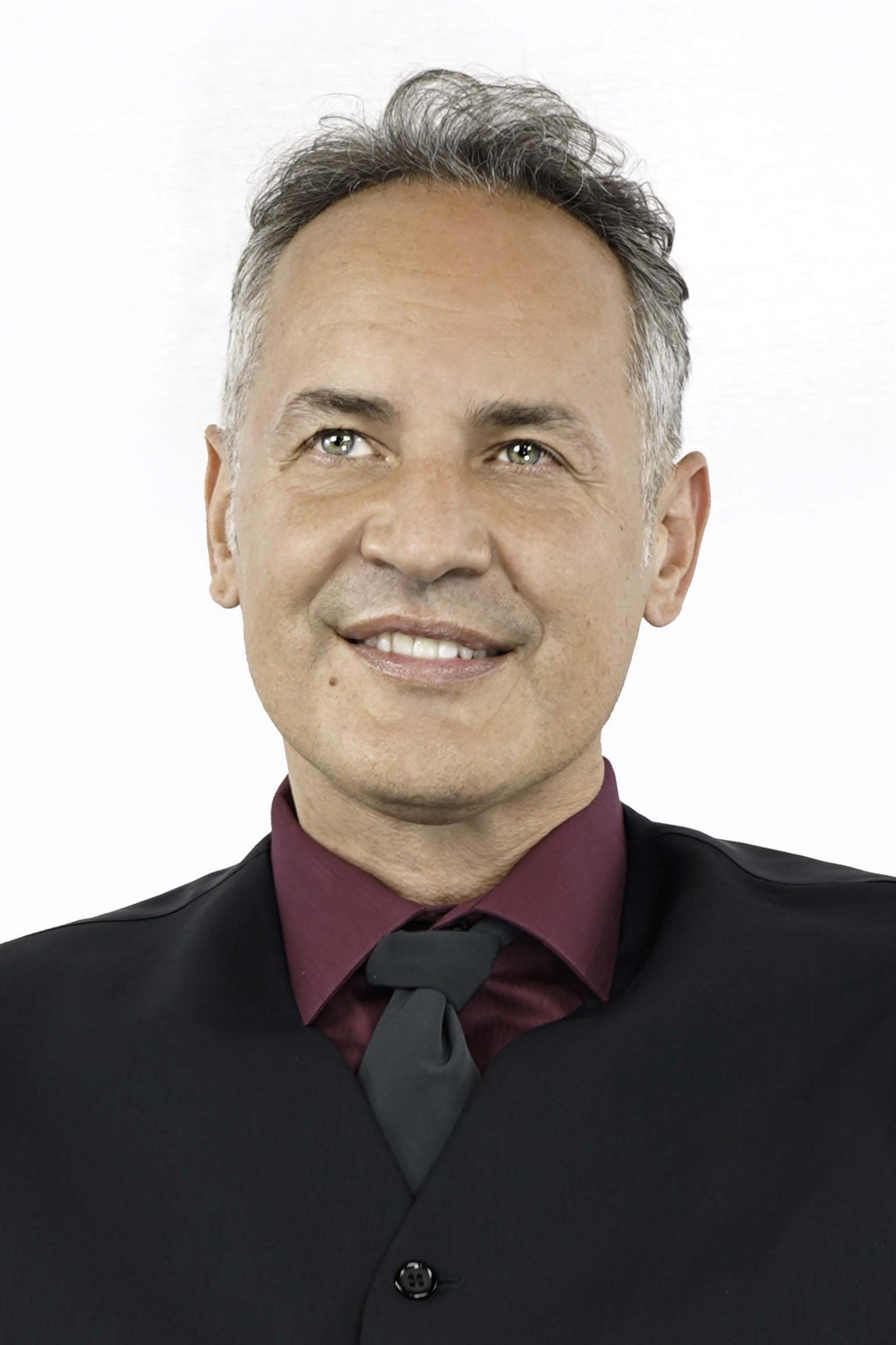 Daniel Vasic standing before an easel holding a paintbrush